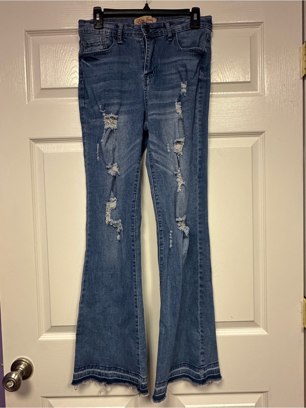 Distressed Blue Flare Jeans with Raw Hem